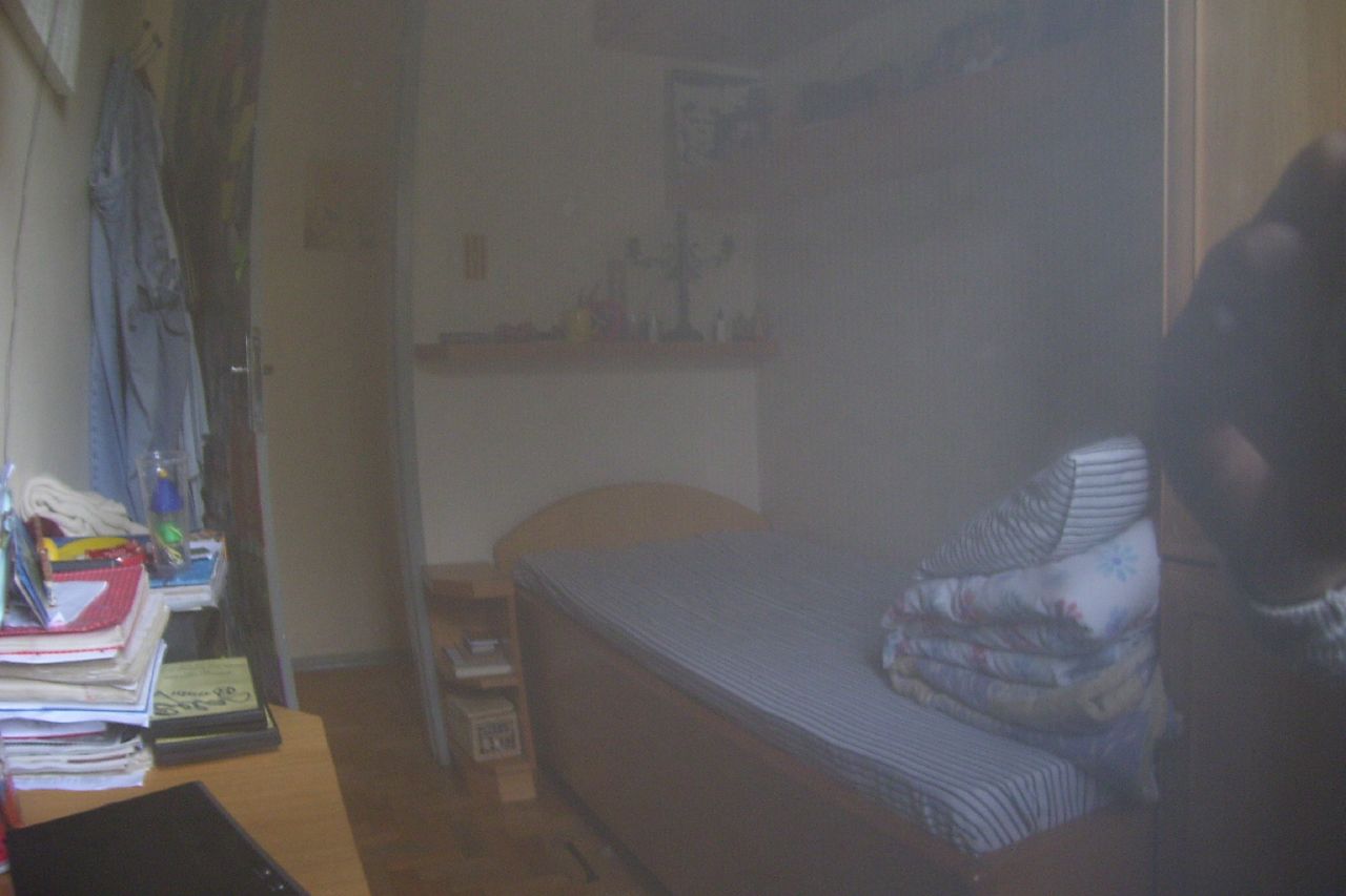 a blurry po of a bedroom and a bed