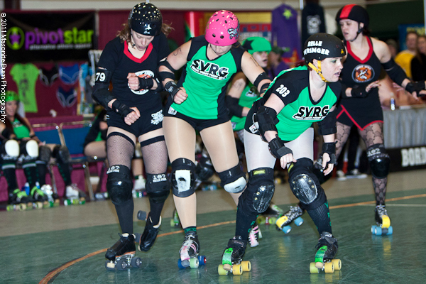 some roller blades players are riding in formation