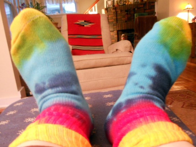 a person's feet wearing colorful socks and stockings