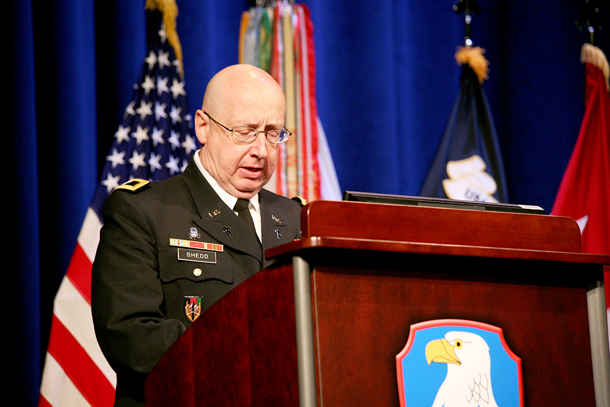 a man in military uniform speaking at a podium