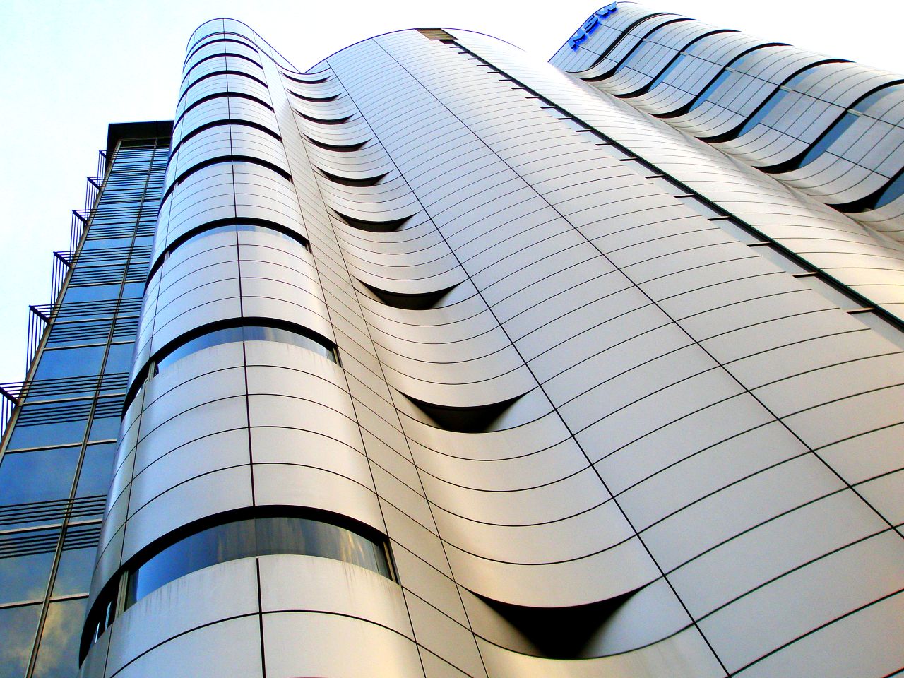 a tall building with multiple curved windows