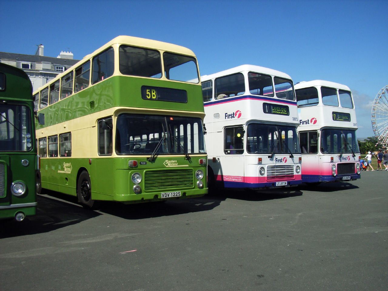 three buses parked on the road next to each other