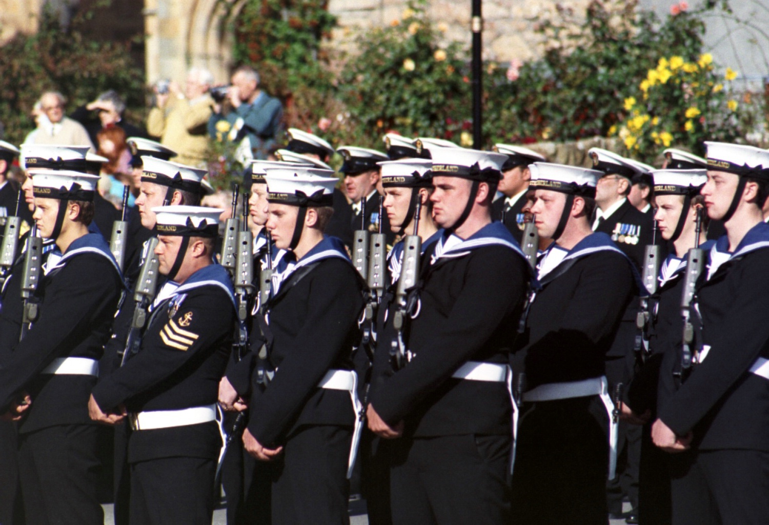 many people in blue uniforms, standing together