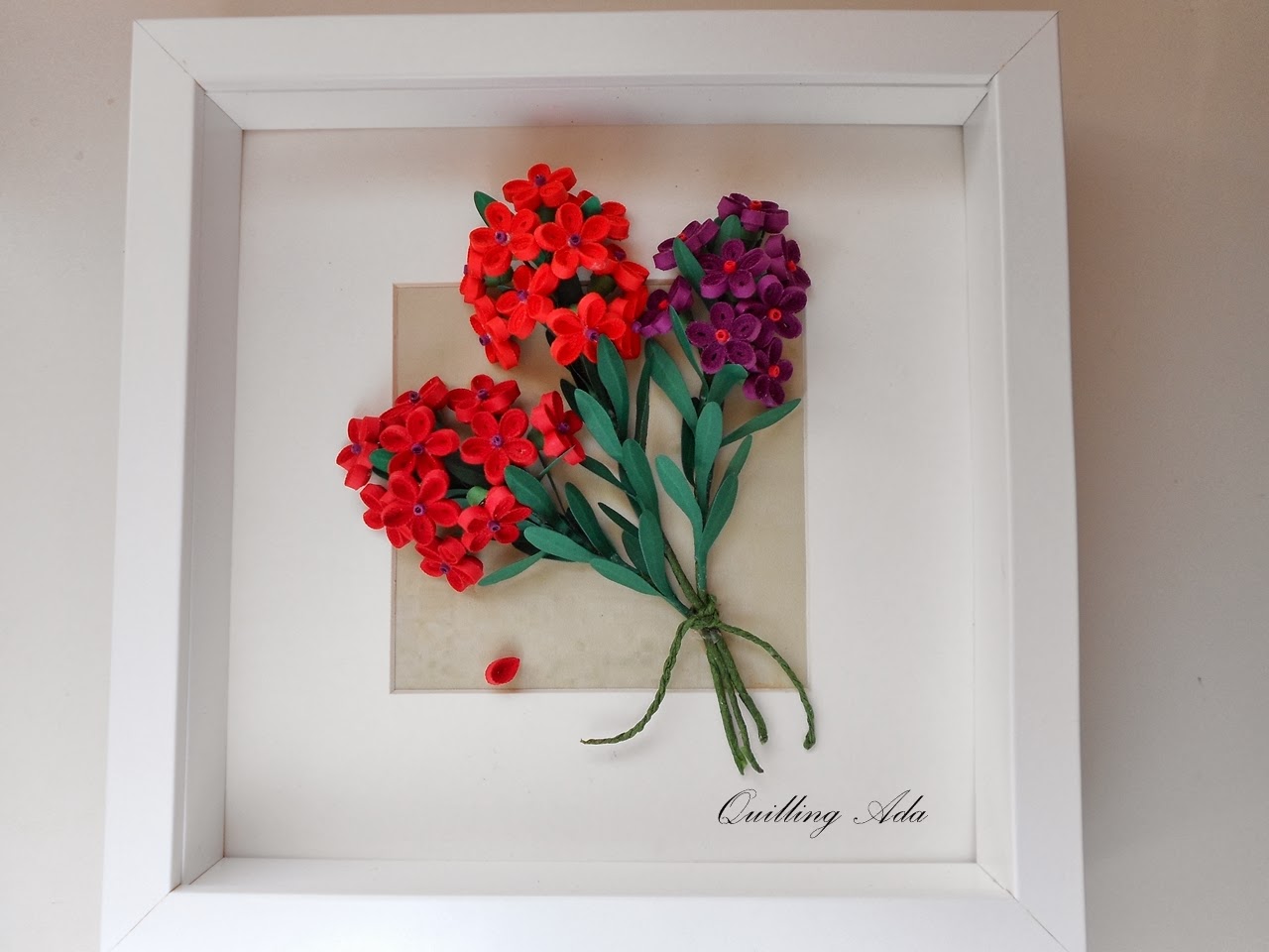 a picture frame with red, purple, and green flowers