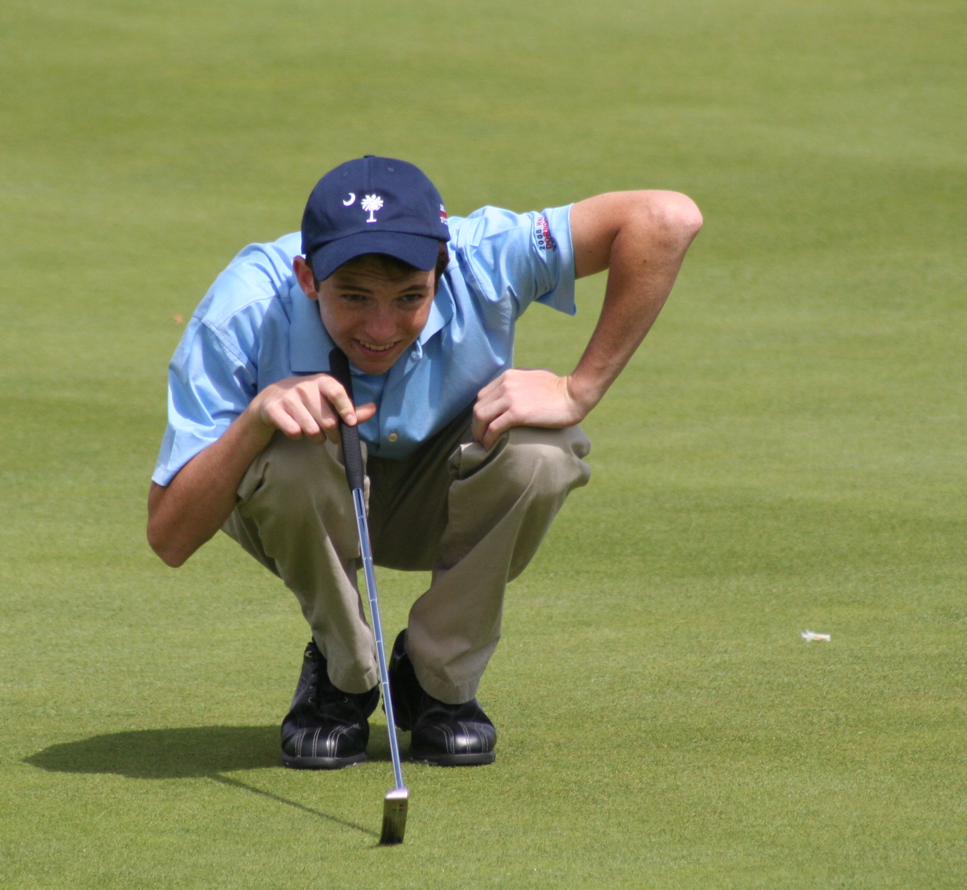 a man putting his golf club in his ground