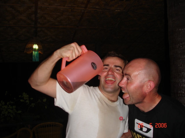 two men are drinking from a pink cup