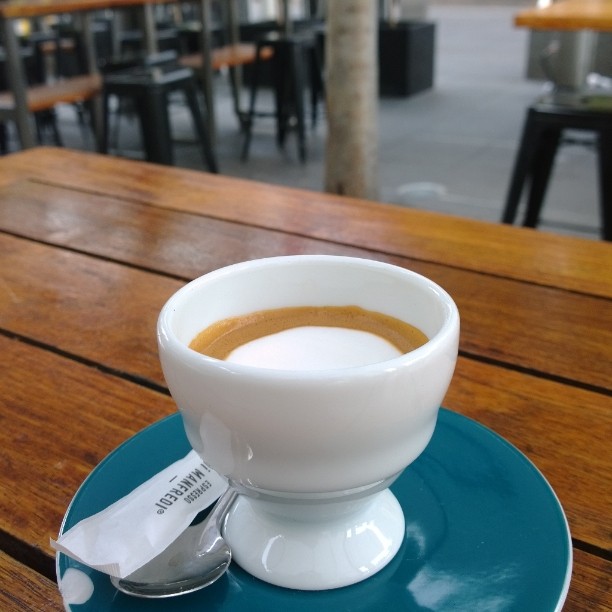 a cup of coffee on a saucer, ready to be eaten