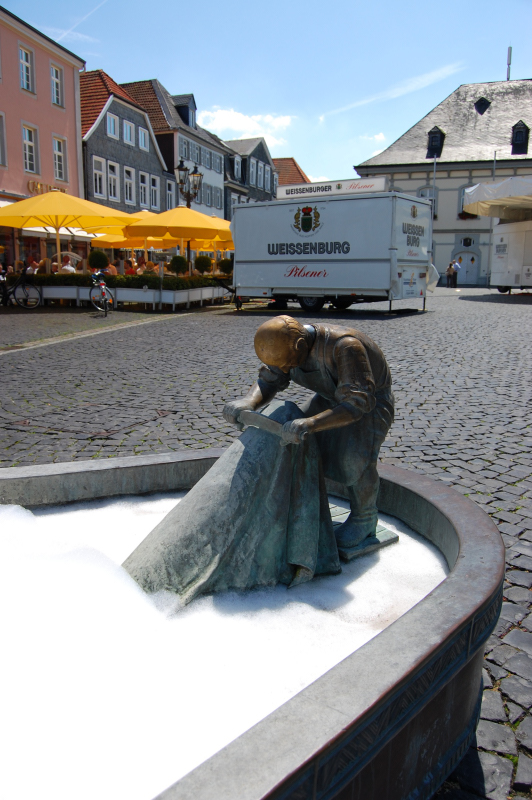 a statue is placed on a cobblestone street