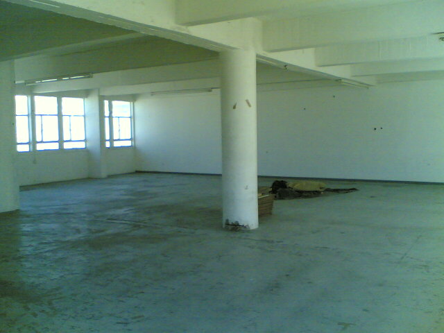 an empty large room with many windows