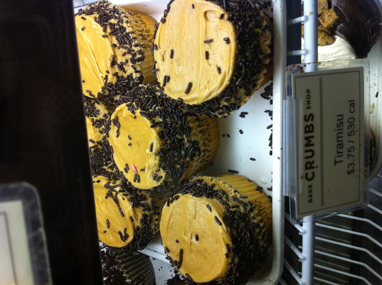 a rack full of cupcakes sitting on a shelf