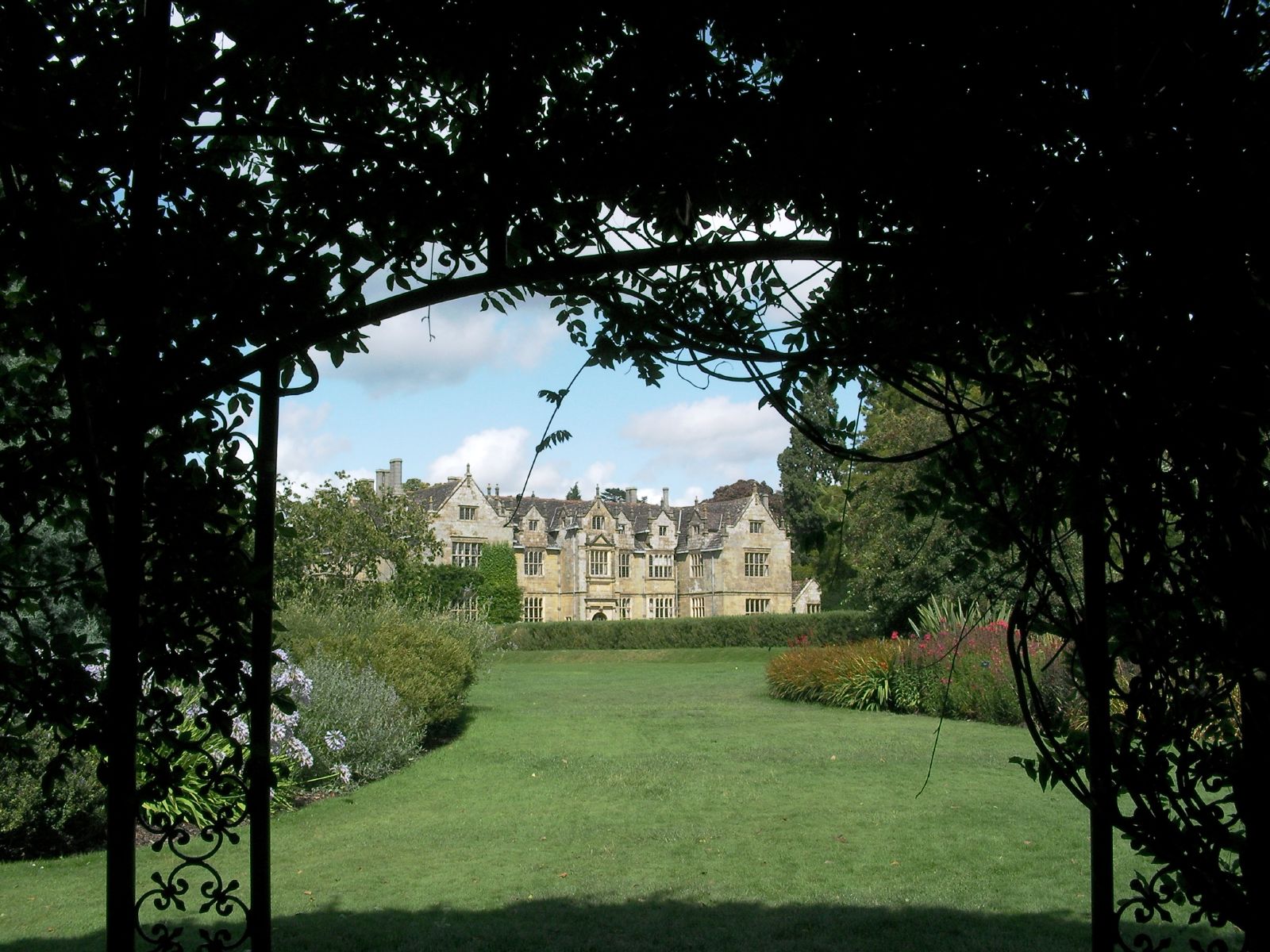 a large home seen through a set of arches