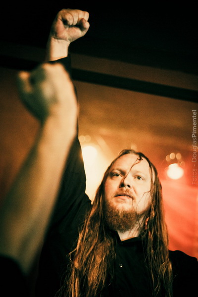 a man with long hair and beards raises his fist