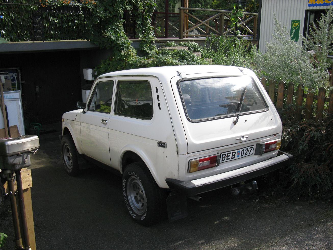 a white toyota truck parked next to a wooden house