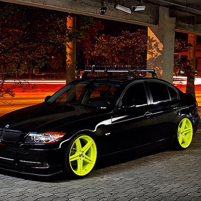this is a black bmw with yellow wheels