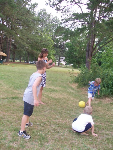 children playing with frisbees on the grassy area