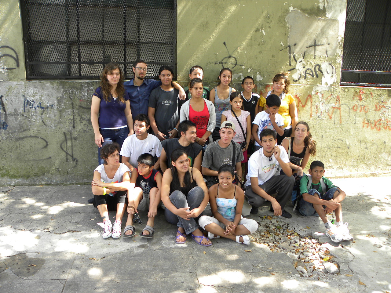 a group of people sitting and standing next to each other