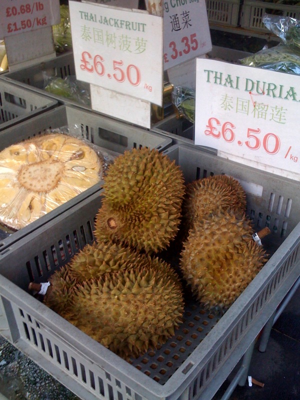 different types of fruit are sitting inside baskets for sale