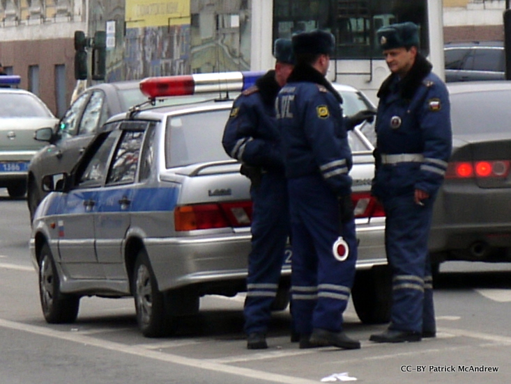 two policemen standing on the side of the street talking