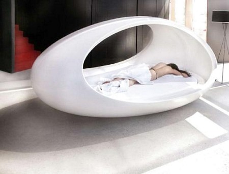 a woman sleeping in an unusual bed made from a balloon