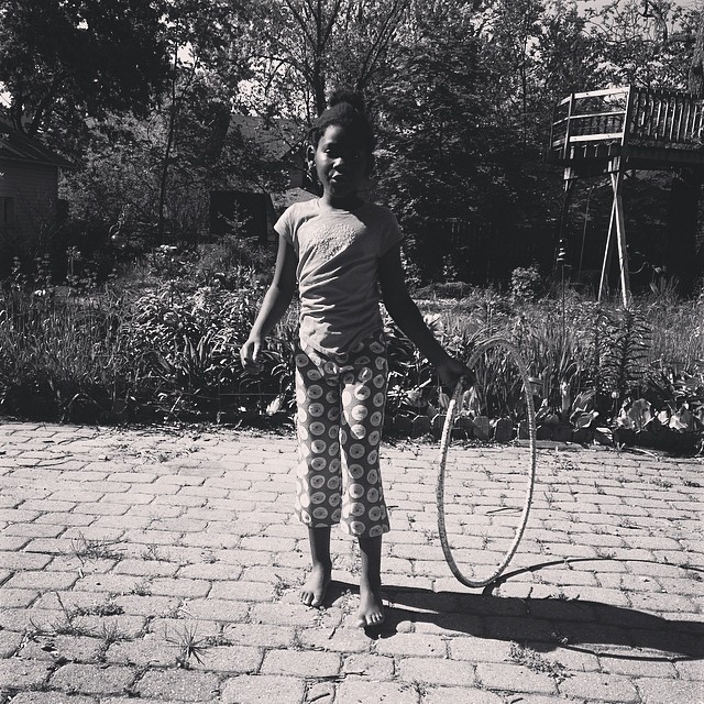 a  stands outside playing with a tennis racket