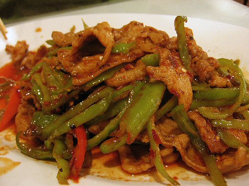 green beans and carrots sit on a plate with meat