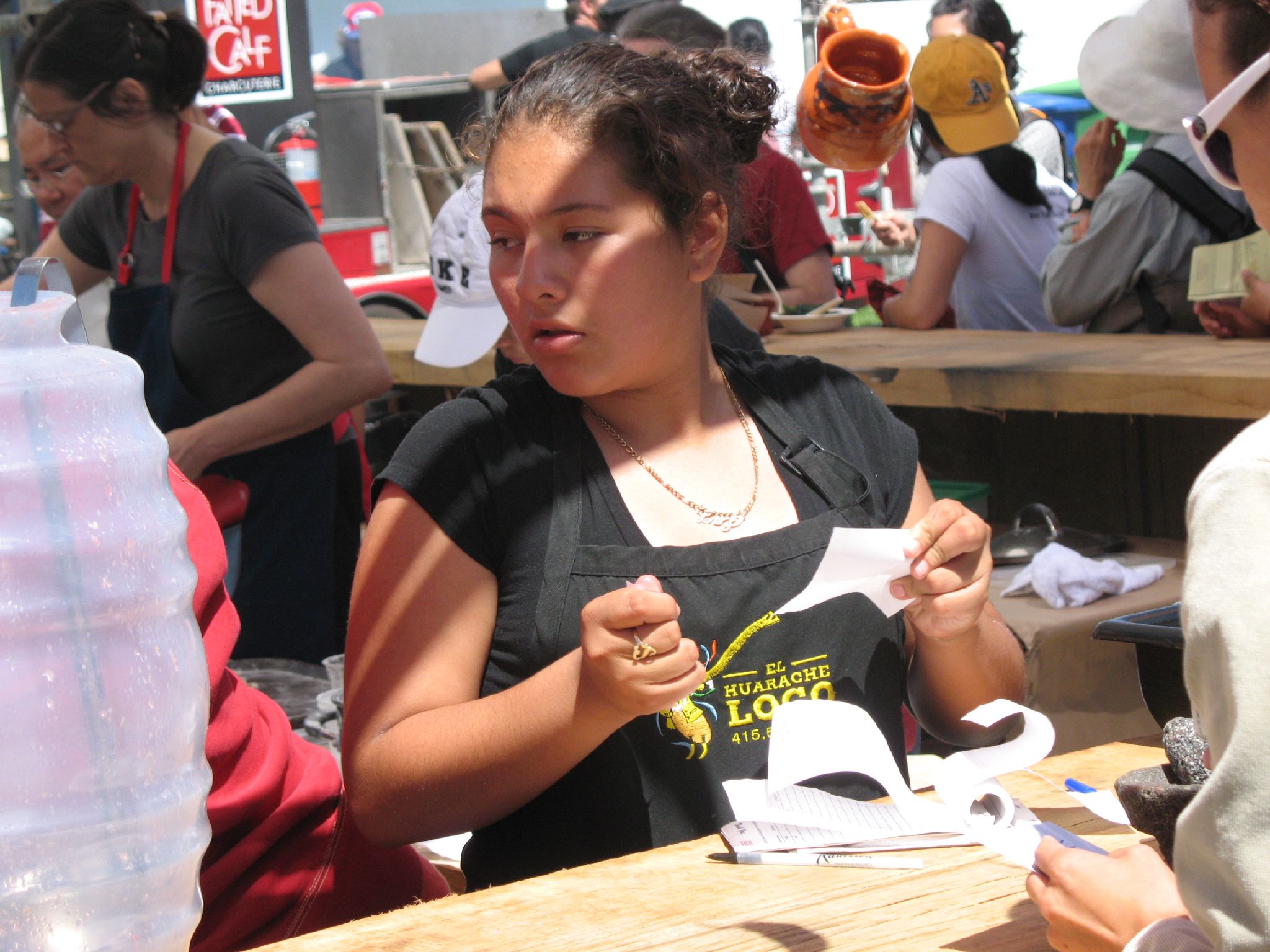 a girl sitting at a table  paper with her hands