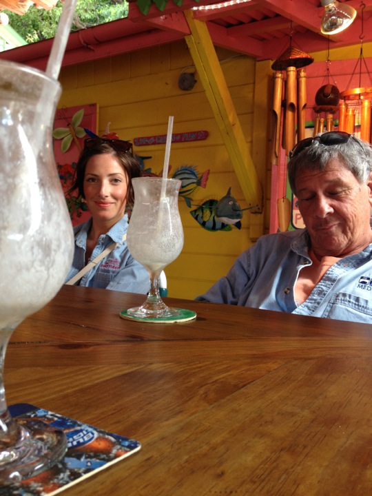 a couple and their daughter sitting at a restaurant bar