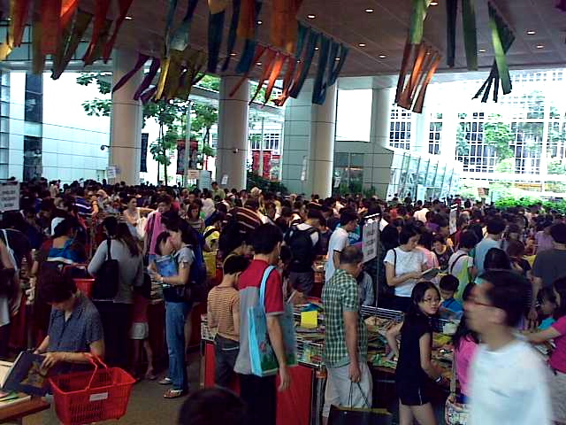 a large crowd of people are lined up in a lobby