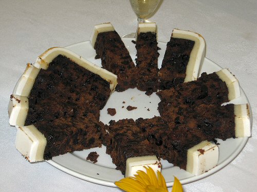 an arrangement of cake with flowers on a plate