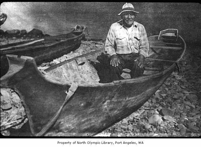 an old po of a man in a canoe