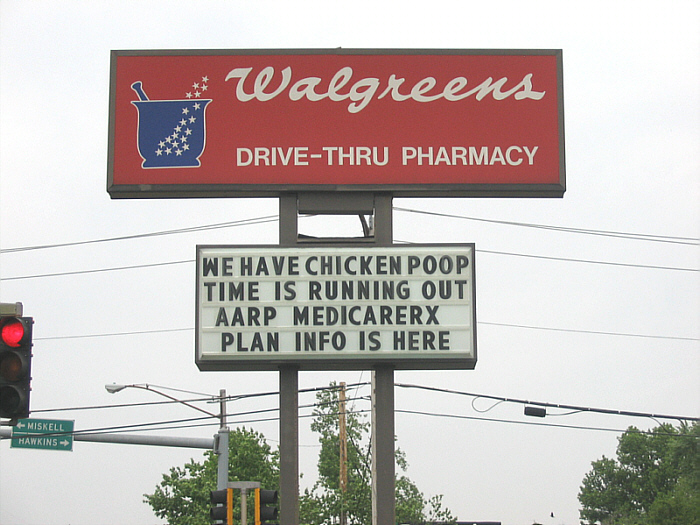 large pharmacy sign with warning of chickens in it