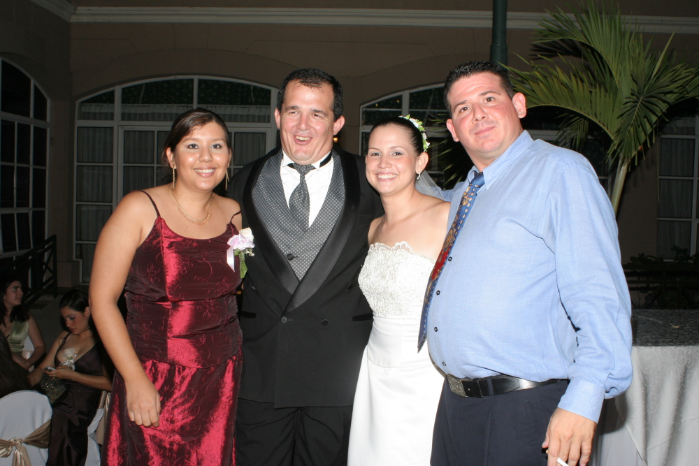 three people in formal wear are posing for a picture