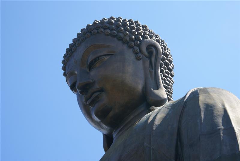 a large buddha statue has its eyes closed