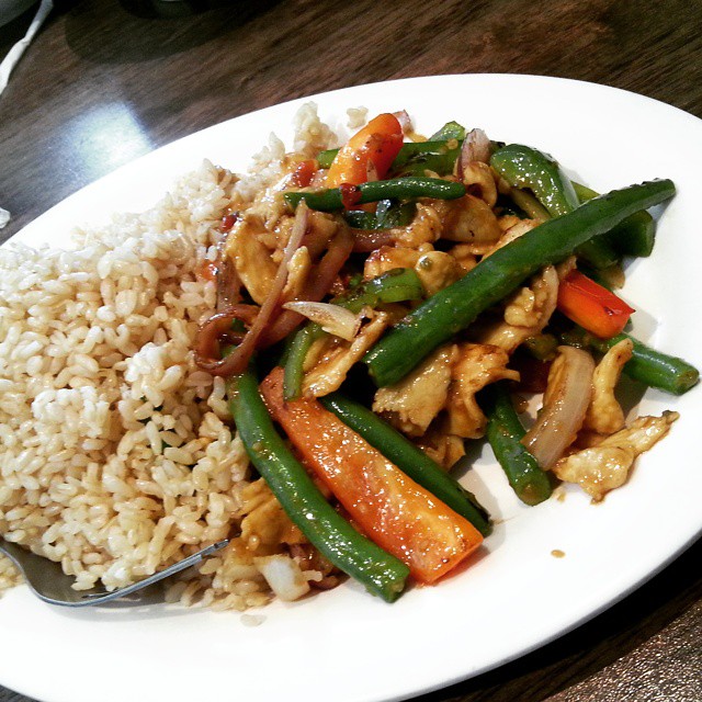 rice and vegetable dish served on plate on wooden table