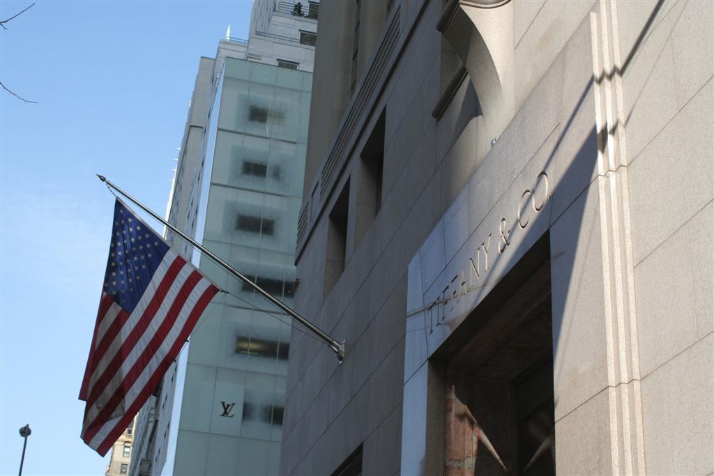 two american flags are flying in front of the building