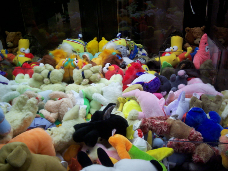 a large pile of colorful stuffed animals on display