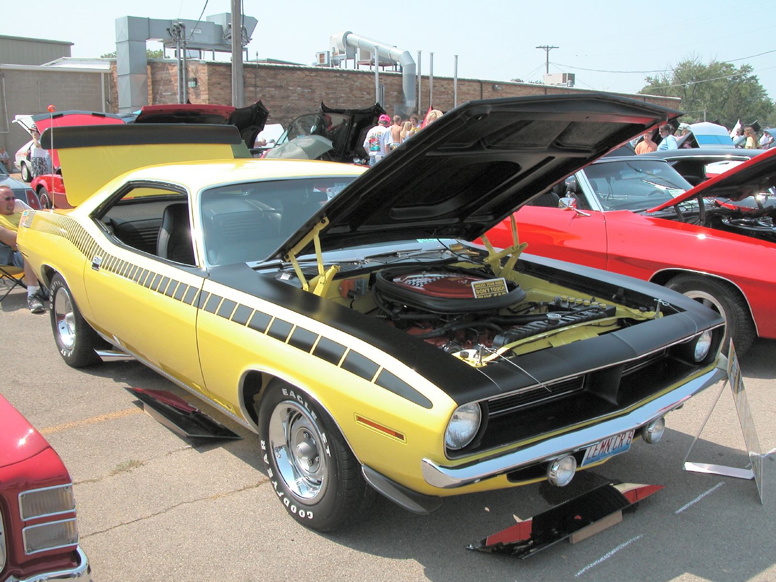 classic muscle car show with yellow car hood