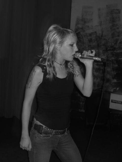 a young woman holding a microphone to her ear