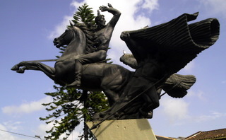 a large statue of two men riding horses