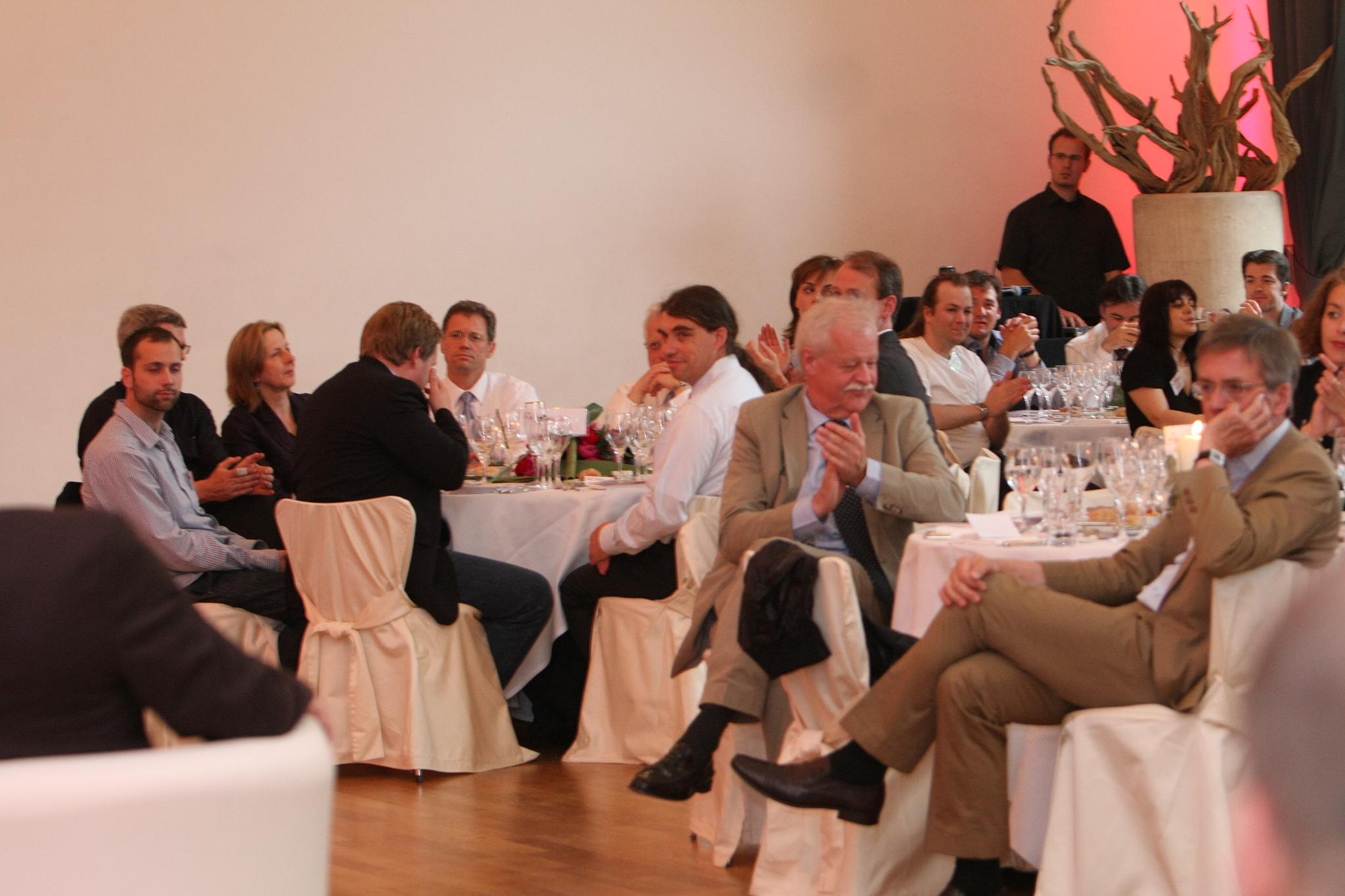 people are enjoying a business dinner at a party