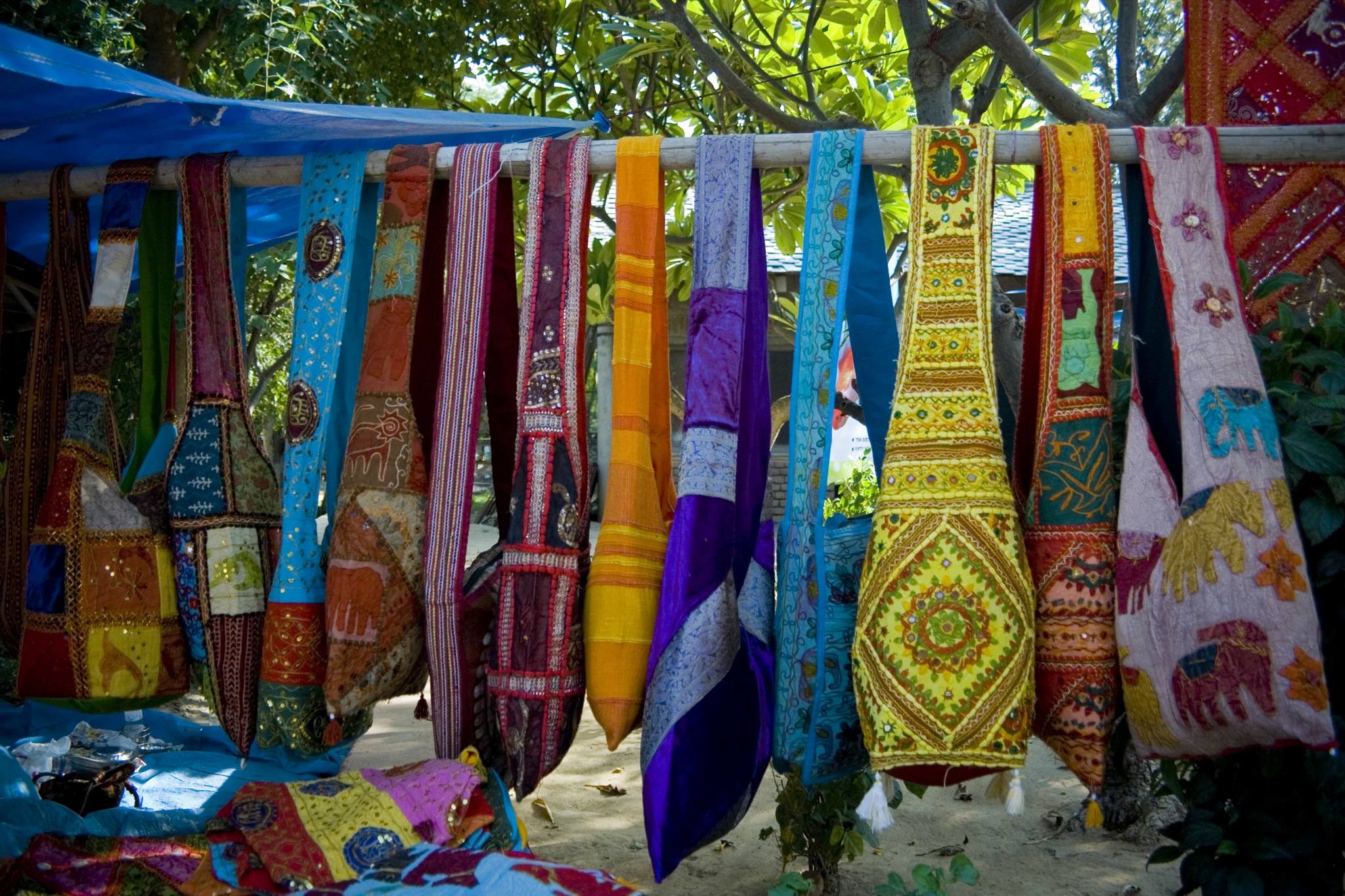 many ties hanging upside down in front of trees