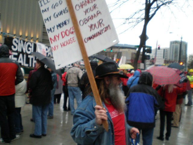 a protester holding a sign at an occupy demonstration