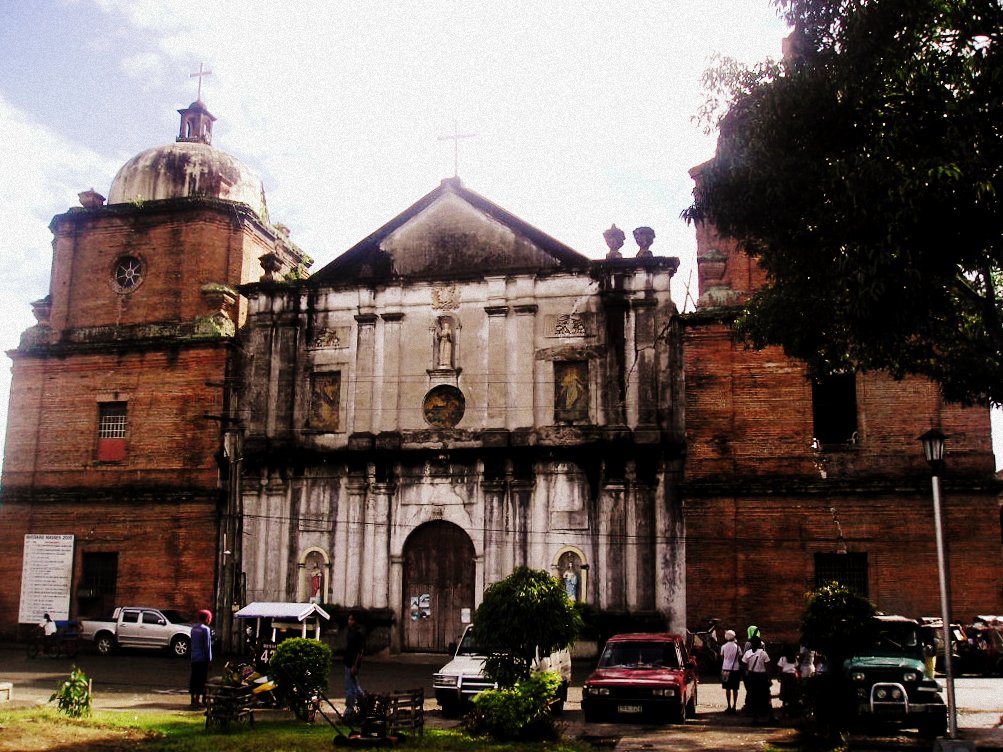 people are standing outside of an old church