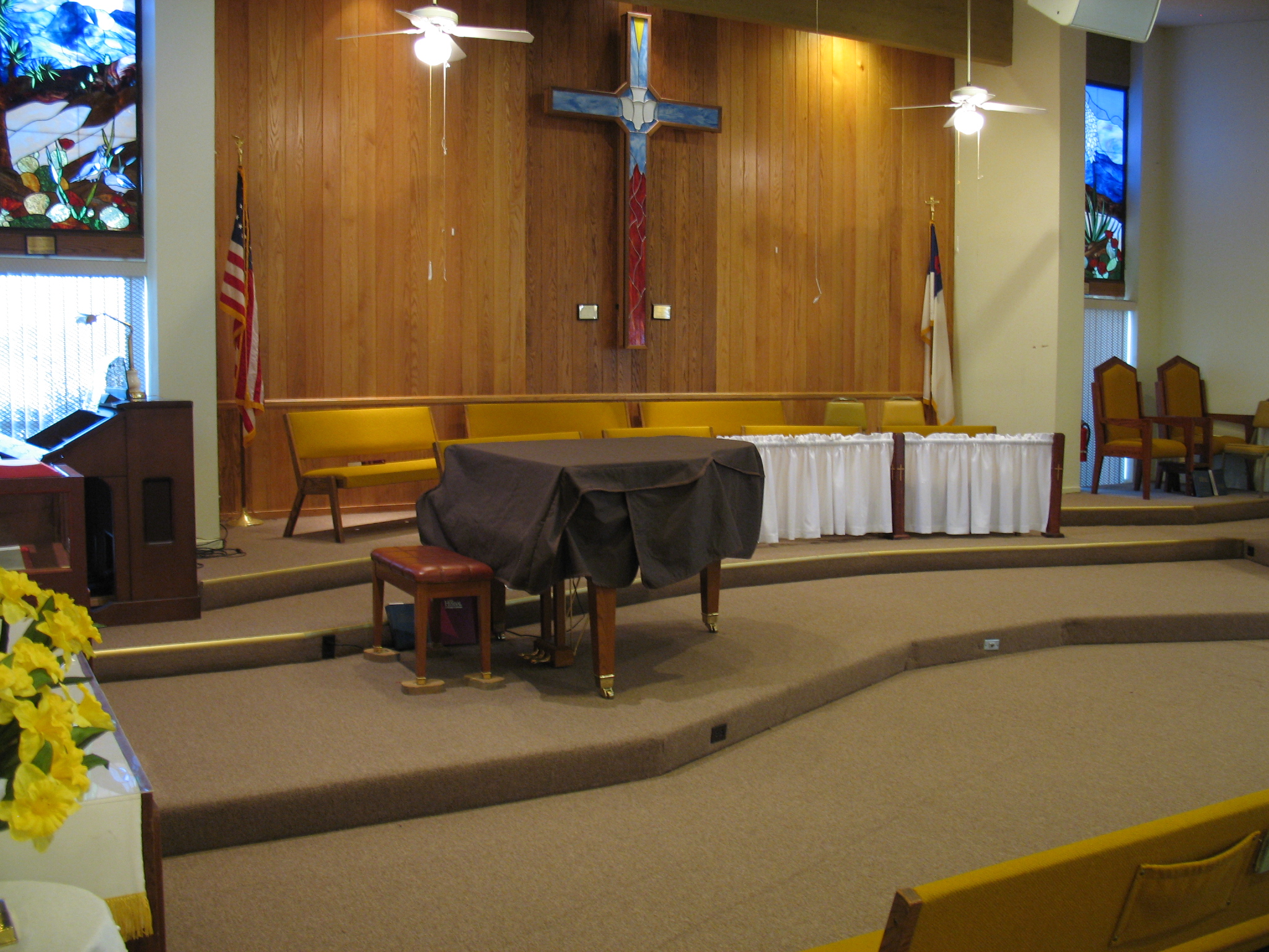 a church has pews with chairs and a sheet covering the area