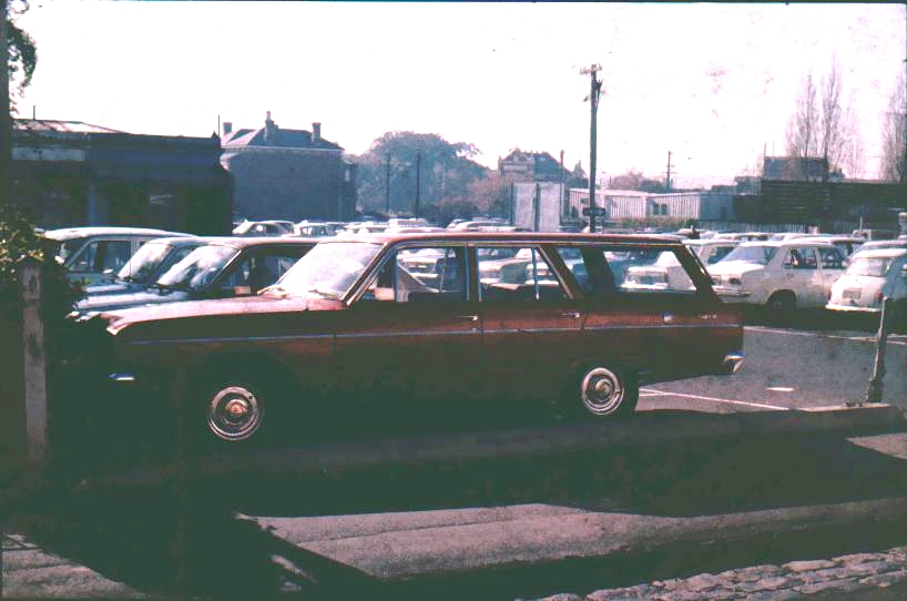 a car that is in front of some parked cars