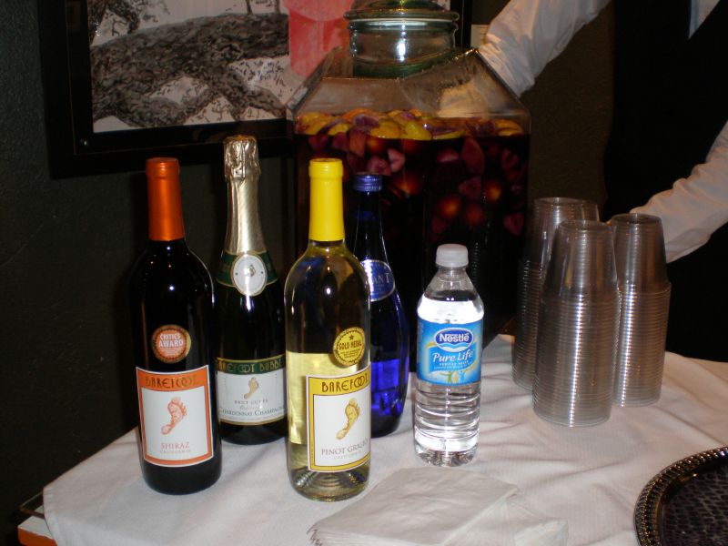 various bottles and glasses sit on a table