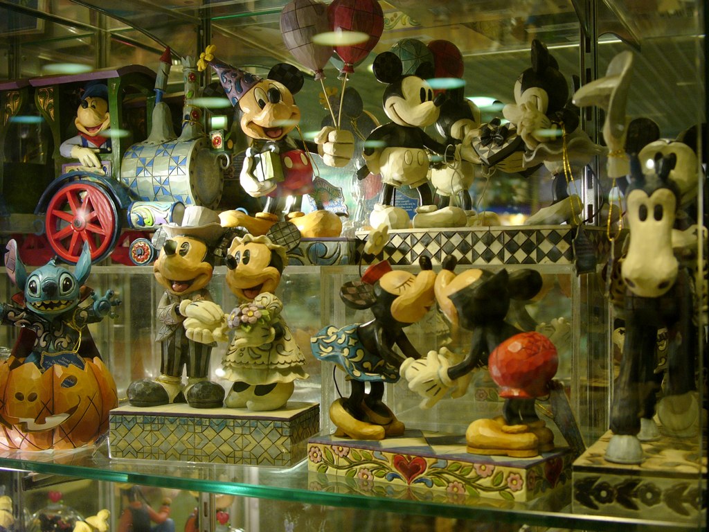 mickey mouse figurines displayed in a store window