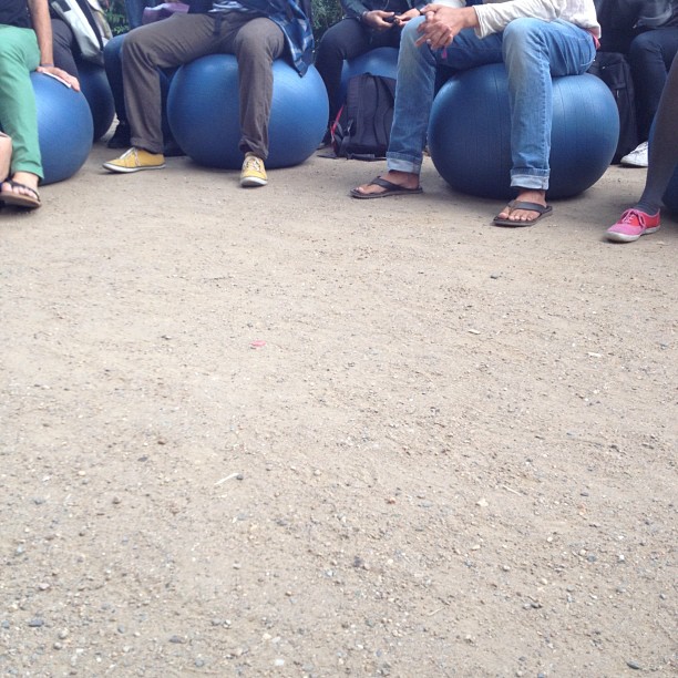there is a group of people sitting on balls