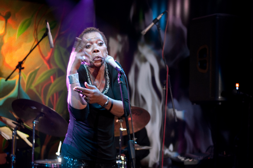 a woman standing in front of a microphone