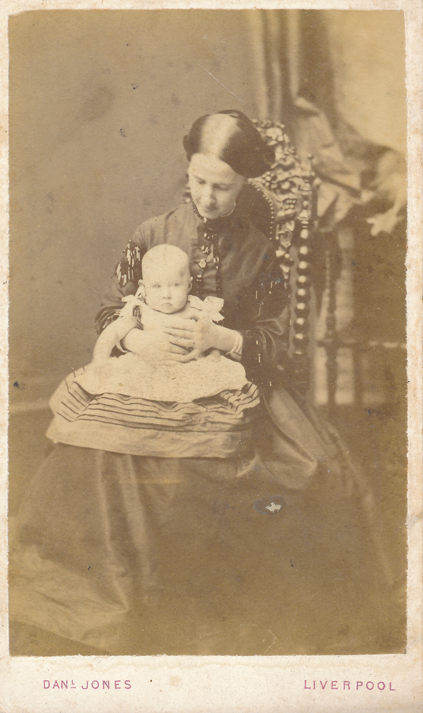 an old fashion picture shows a woman with a baby